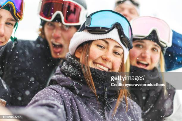 generation z youth skiing and snowboarding activities at ski resort town in the colorado rockies - colorado ski resort stock pictures, royalty-free photos & images
