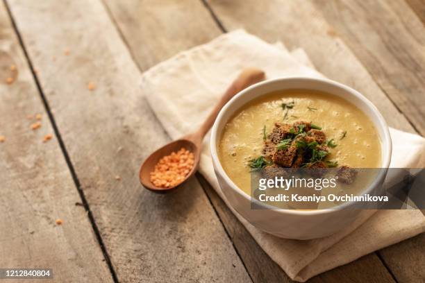 lentil soup in a wooden dish - lentil soup stock pictures, royalty-free photos & images