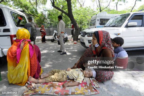 Noida Police stop migrants trying to walk from Ghaziabad back to Madhya Pradesh and ask them to return to their starting points, from Sector 49...