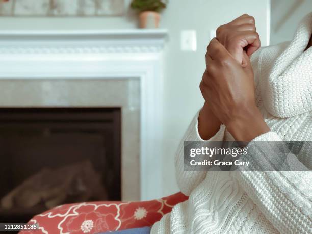 woman holds hand in pain - rheumatism stock pictures, royalty-free photos & images