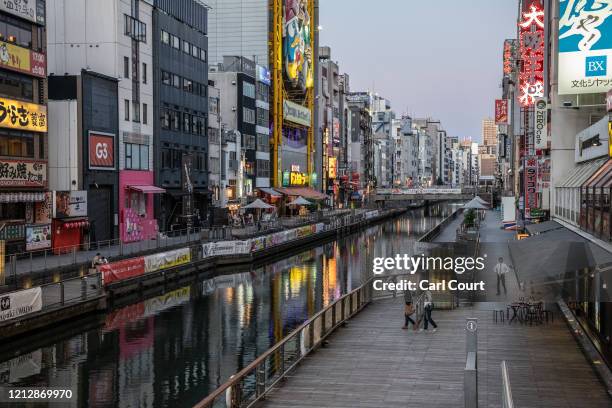People wllk alongside the canal in Dotonbori, one of Osaka's most popular tourist areas, on May 13, 2020 in Osaka, Japan. Japan's Prime Minister,...
