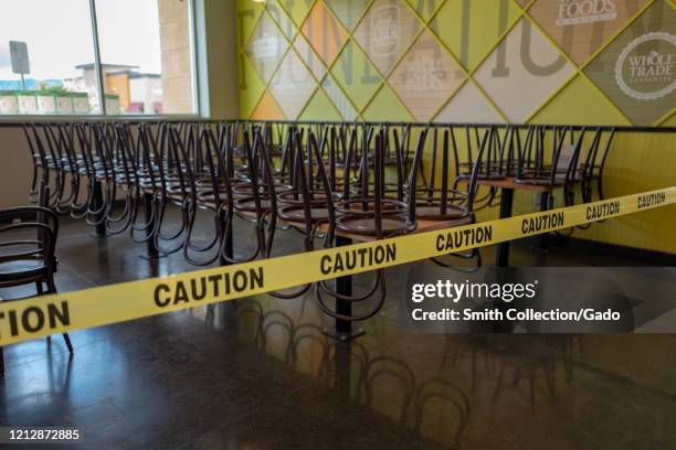 Chairs are wrapped in caution tape at a restuarant in Dublin, California following shelter in place orders in the San Francisco Bay Area during an...