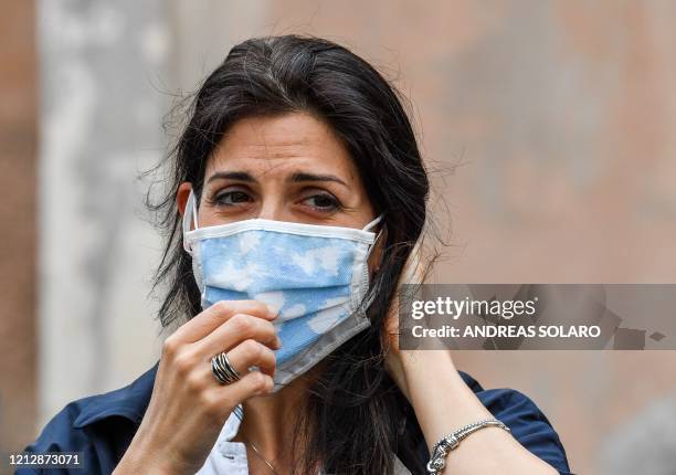 Rome mayor Virginia Raggi, wearing a face mask, arrives to attend the sanitation of the Santuario della Madonna del Divino Amore church on May 13,...
