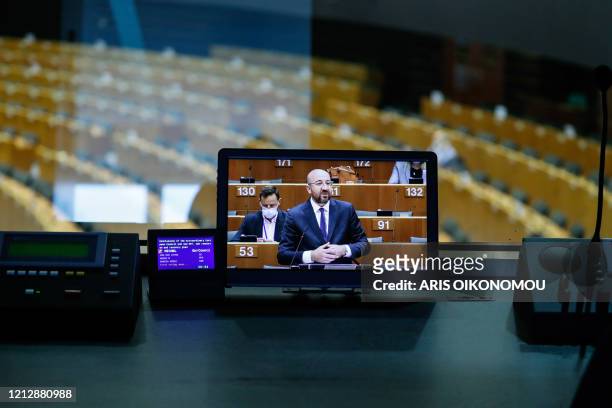 European Council President Charles Michel is seen on a monitor as he speaks during a plenary session of the European Parliament in Brussels on May 13...