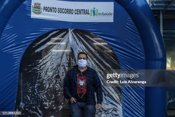 Man wearing a face mask walks through a disinfection tunnel at Dr. Armando Gomes de Sá Couto ER during the coronavirus pandemic on May 13, 2020 in...