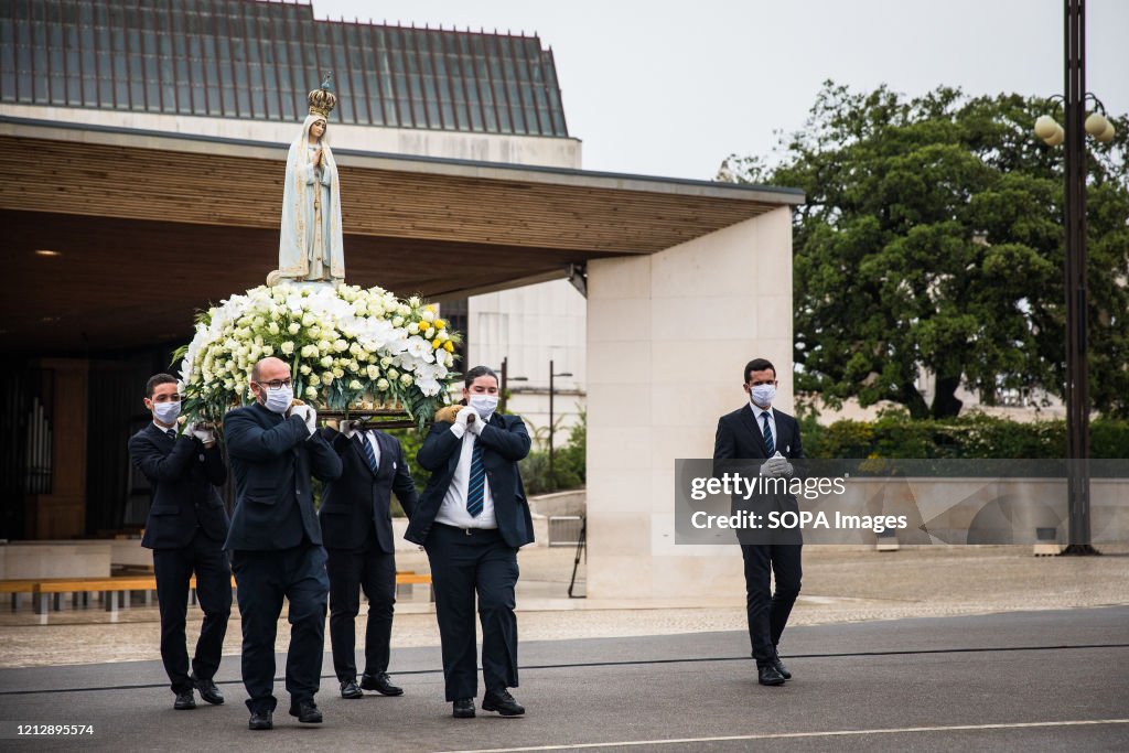 Men carry the figure of Our Lady of Fatima, during the...