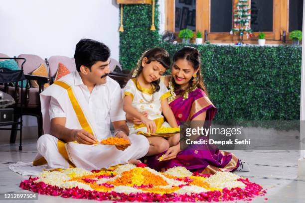 south indian young family with classic look stock photo - rangoli stock pictures, royalty-free photos & images