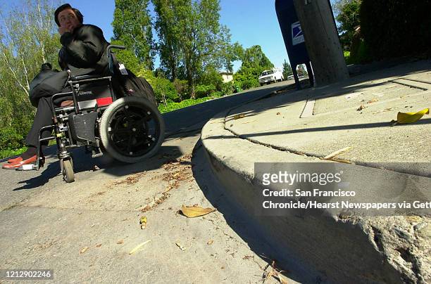 Because there's no handicapped access at this El Cerrito sidewalk bus stop, when waiting for the bus, Janet either has to move herself in her...