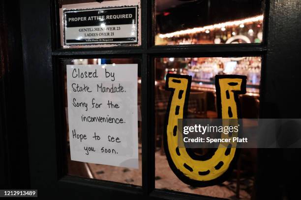 Restaurant sits closed in the early evening in Brooklyn after a decree that all bars and restaurants shutdown by 8 pm in New York City as much of the...