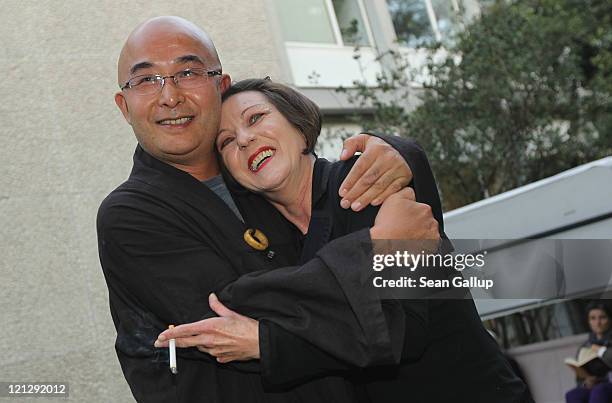 Chinese dissident writer Liao Yiwu is greeted by German writer Herta Mueller at the Haus der Berliner Festspiele during the Berlin International...