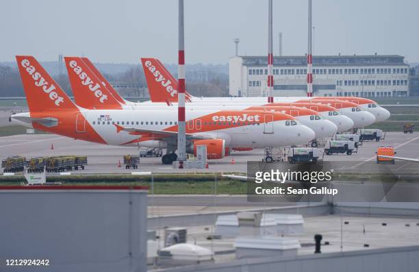 Passenger planes of discount airline EasyJet stand on the tarmac at Berlin-Schoenefeld Airport on March 17, 2020 in Schoenefeld, Germany. EasyJet and...