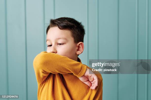 6-7 years old cute child wearing surgical mask. - tossir imagens e fotografias de stock