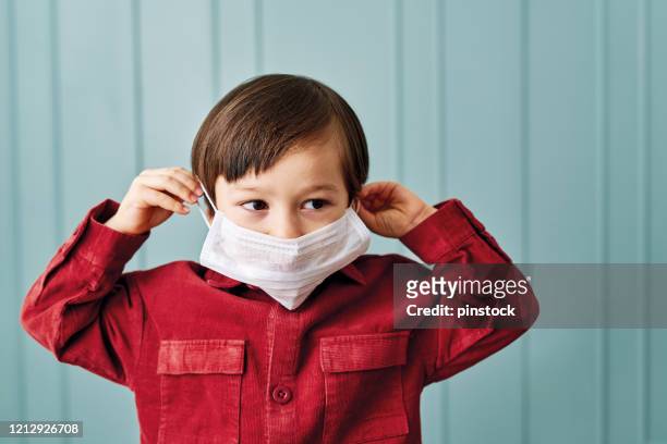2-3 years old cute child wearing surgical mask. - 2 3 years stock pictures, royalty-free photos & images