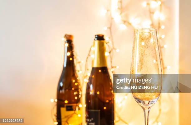 champagne glass with golden glitter. celebration with champagne - champagne or photos et images de collection