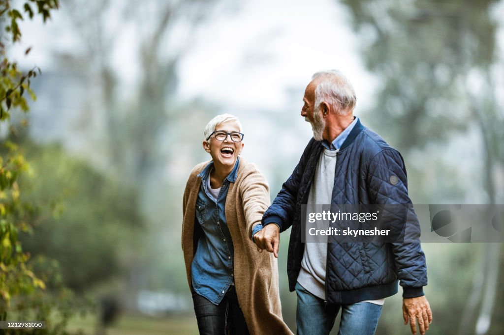 Playful senior couple having fun in the park.