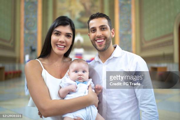 godparents with a godson baby at baptism celebration - godparent stock pictures, royalty-free photos & images