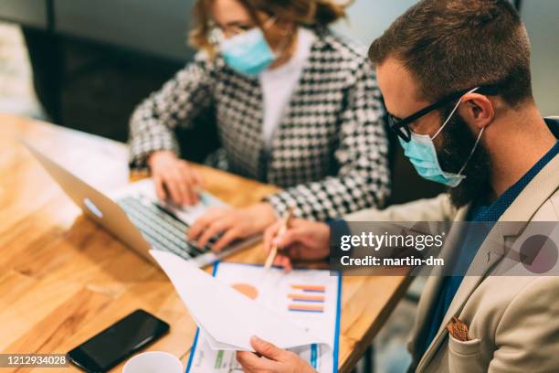 businesspeople working late at night - surgical mask man stock pictures, royalty-free photos & images