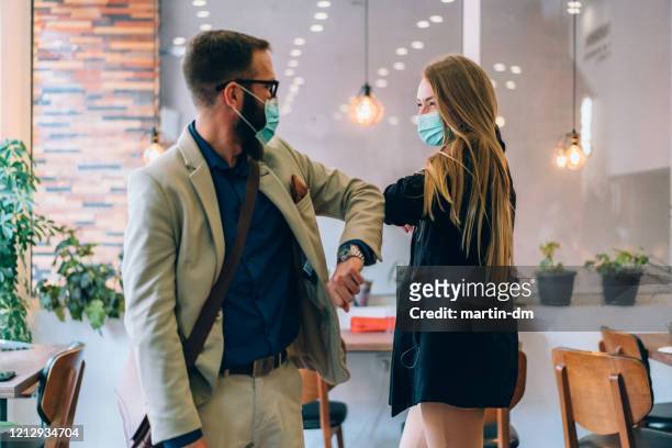 business people greeting during covid-19 pandemic - covid greeting stock pictures, royalty-free photos & images