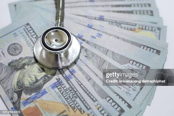 dollar and stethoscope - patient protection and affordable care act stock-fotos und bilder