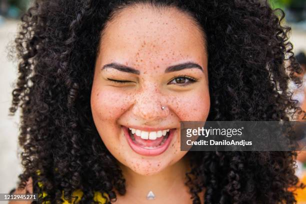 portrait of young beautiful woman - curly black hair stock pictures, royalty-free photos & images