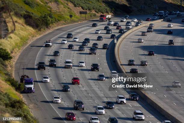 Increasing afternoon commuter traffic streams northward from Los Angeles on the State Route 14 freeway, as more people take to the roadways while the...