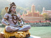 Statue of Shiva sitting in meditation on the riverbank of Ganga in Rishikesh.