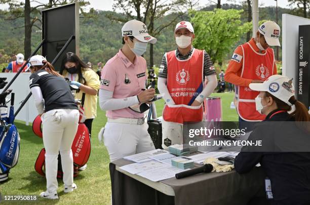 South Korean golfer Park Sung-hyun wearing a face mask arrives at the first hole during the first round of the 42nd KLPGA Championship at Lakewood...