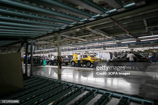 Employees wearing protective masks as a precaution against Covid-19 work in the assembly line for the Volkswagen T-Roc at Autoeuropa's car factory....