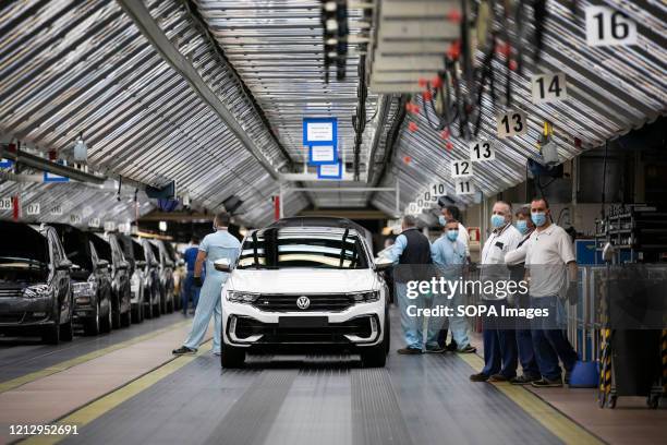 Employees wearing protective masks as a precaution against Covid-19 work in the assembly line for the Volkswagen T-Roc at Autoeuropa's car factory....