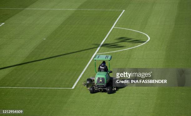 Lawnmower drives on the pitch at the training grounds of German first division Bundesliga football club FC Schalke 04 in Gelsenkirchen, western...