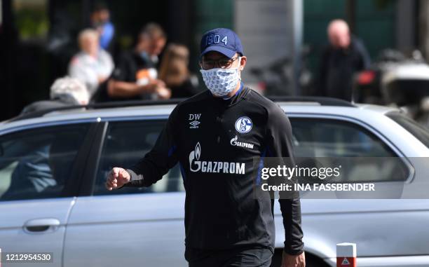 Schalke 04's German headcoach David Wagner walks with a face mask from the hotel, where the team stays in quarantine, to the club's training grounds...