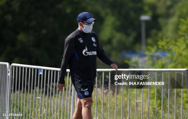 Schalke 04's German headcoach David Wagner walks with a face mask at the club's training grounds before a training session in Gelsenkirchen, western...