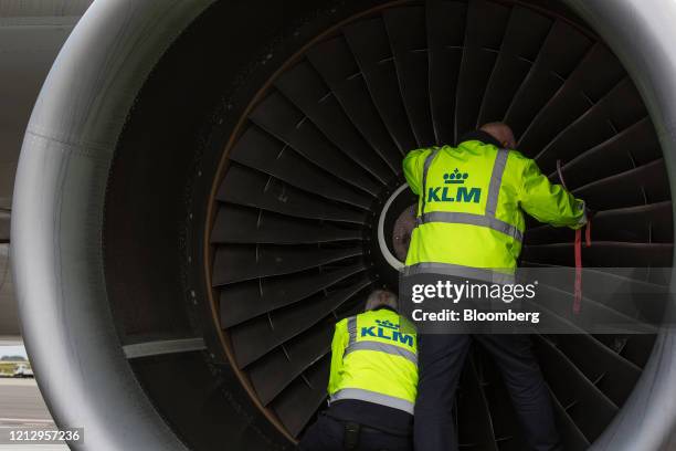 Members of the Line Maintenance Department inspect engine turbine blades on an Airbus SE A330-200 aircraft while carrying out essential tests on all...