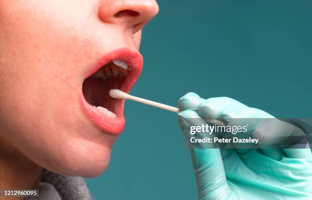 woman having swab test - bava foto e immagini stock