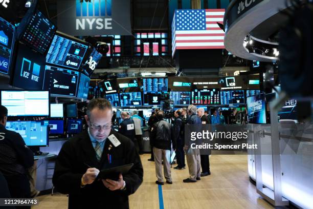 Traders work on the floor of the New York Stock Exchange on March 17, 2020 in New York City. The Dow was up slightly in morning trading following a...