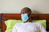 An African-American man wearing a protective face mask to prevent virus infection