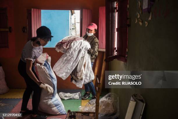 Volunteers from the association Le Caméléon are preparing clothes from donations that will be distributed to residents of the Anjezika neighborhood...