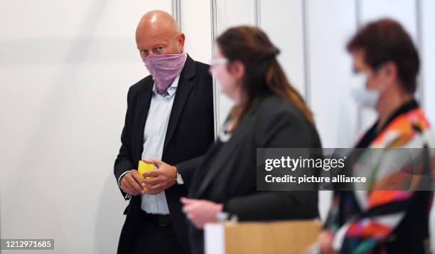 May 2020, Thuringia, Erfurt: Thomas Kemmerich , former Minister President of Thuringia, comes out of the voting booth with voting papers during the...