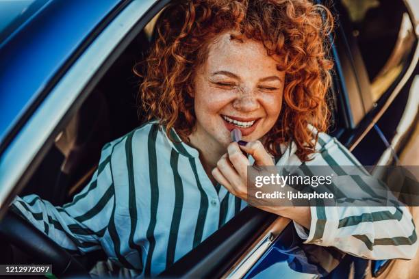 women on road trip doing makeup in a moving car - candid curly hair stock pictures, royalty-free photos & images