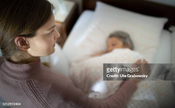 In this photo illustration a relative comforts the sick woman on May 12, 2020 in Radevormwald, Germany.