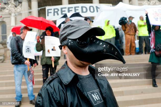 Demonstrators protest in Lansing, Michigan, during a rally organized by Michigan United for Liberty on May 14 to protest the coronavirus pandemic...