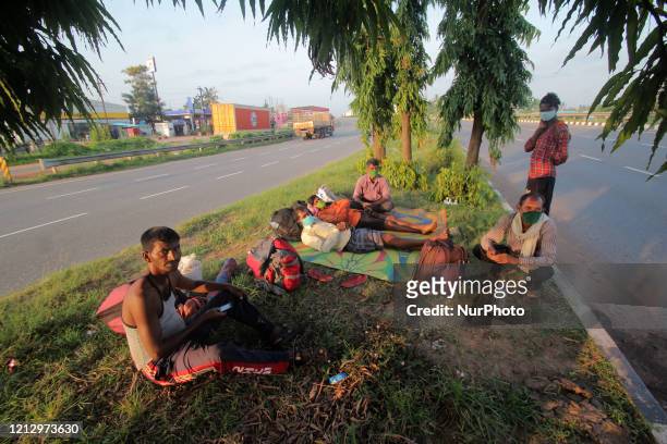Migrant laborers are seen on wayside and roads as they rests in between their walking journey outskirts of the eastern Indian state Odisha's capital...