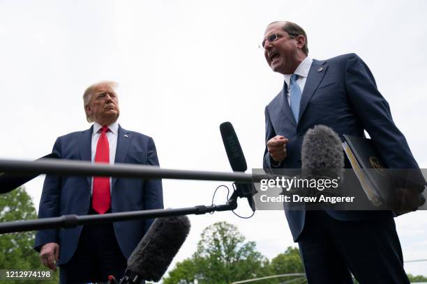 President Donald Trump and Health and Human Services Secretary Alex Azar speak to reporters on his way to Marine One on the South Lawn of the White...