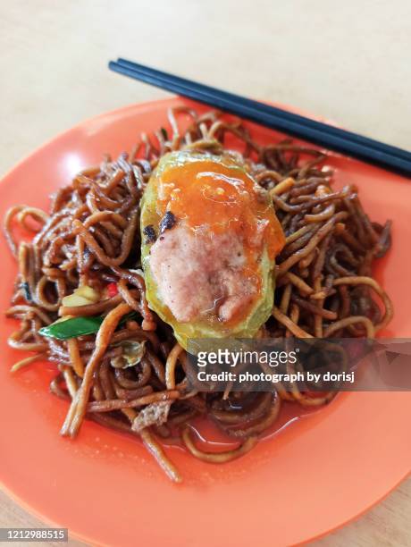 fried noodles with bitter gourd stuff with mince pork - traditional malay food stock pictures, royalty-free photos & images