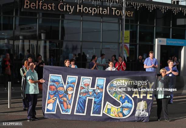 Staff outside the Nightingale Hospital in south Belfast, as they join in the applause to salute local heroes during Thursday's nationwide Clap for...