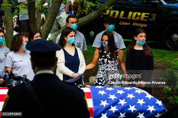 Family and police officers attend the funeral service of Glen Ridge Police Officer Charles Roberts after he passed away from the coronavirus, on May...