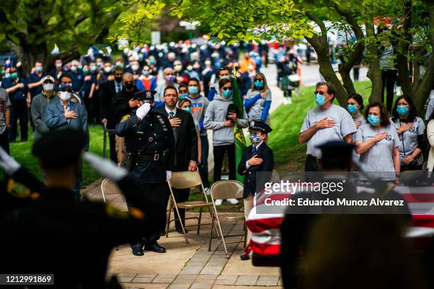 Police officers, family and residents pay their respects during the funeral of Glen Ridge Police Officer Charles Roberts after he passed away from...