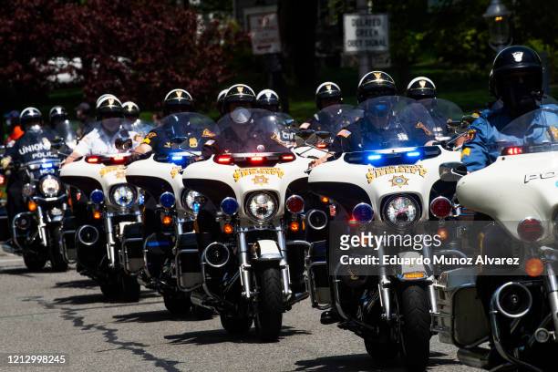 Motorcade rides with the procession during the funeral of Glen Ridge Police Officer Charles Roberts after he passed away from the coronavirus, on May...
