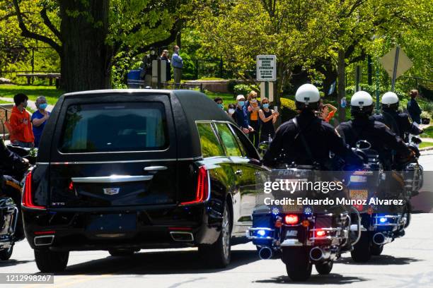 Residents watch the procession during the funeral of Glen Ridge Police Officer Charles Roberts after he passed away from the coronavirus, on May 14,...