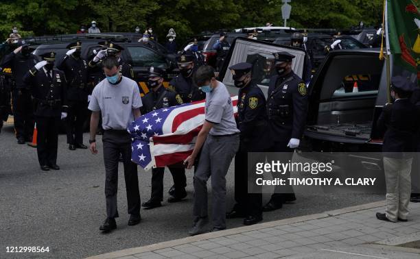 Pallbearers carry the casket of Glen Ridge Police Officer Charles Rob Roberts who died of coronavirus, weeks after contracting the disease while on...